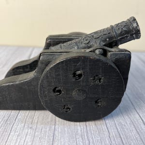 Wood and embossed cast cannon