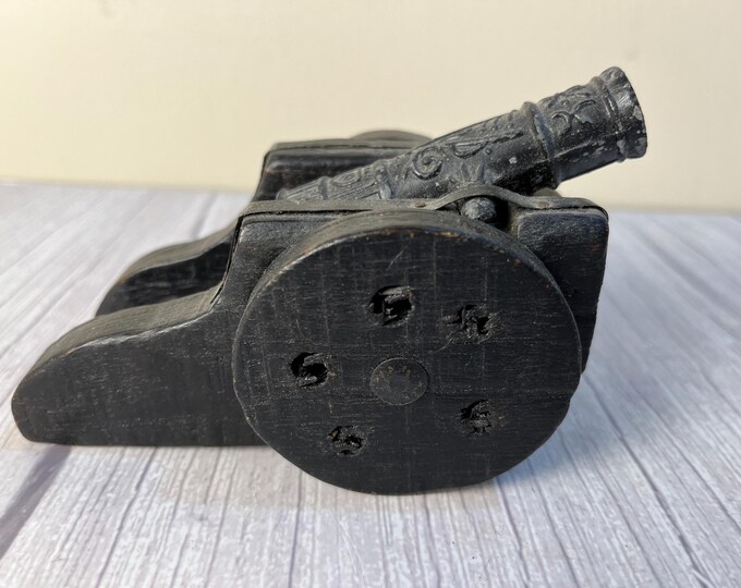 Wood and embossed cast cannon
