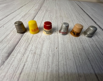 Vintage plastic and metal advertising thimbles