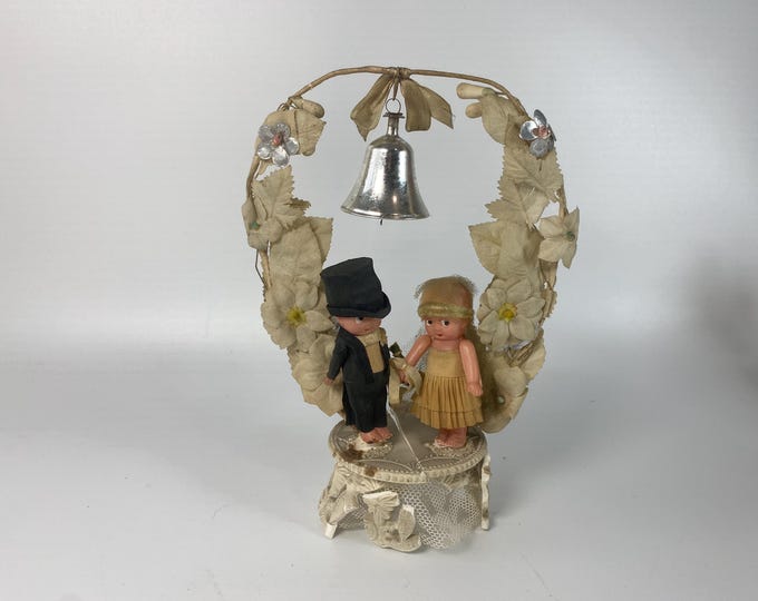 1930s Celluloid Kewpie Bride and Groom Cake Topper on Plaster Base with Floral Arch and Bell