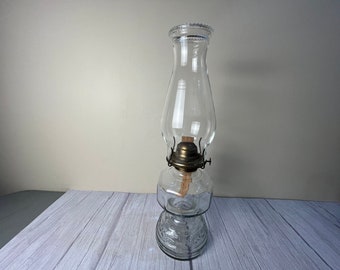 male 12 panel with decorative scrolling clear glass oil lamp with beaded chimney and wick.