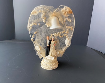 Chalkware Bride and Groom on Wedding Cake Tiered Base Cake Topper w/heart wire netted arch Lily of Valley sprays & bell from Coast Novelty