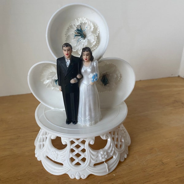 1950 Wedding Cake topper with 3 bells, flowers, bride and groom and horseshoe that says "GOOD LUCK"