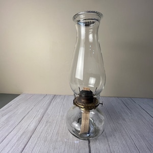 Clear round plain glass finger oil lamp with beaded chimney and wick