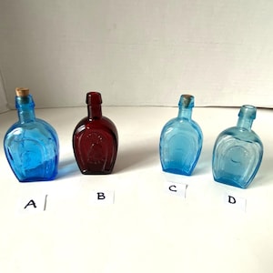 Small Wheaton Ruby Red Horseshoe Glass Bottle  and Aqua Blue Taiwan Horseshoe glass bottles- some with corks