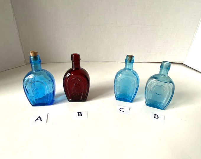Small Wheaton Ruby Red Horseshoe Glass Bottle  and Aqua Blue Taiwan Horseshoe glass bottles- some with corks