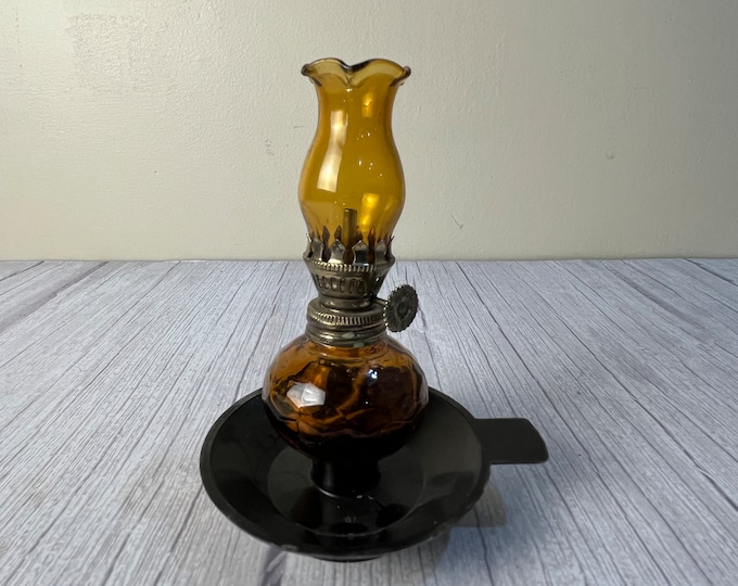 Amber Home Decorative Product # 1967 miniature oil Lamp with scalloped amber chimney and wick on black plastic base with tab