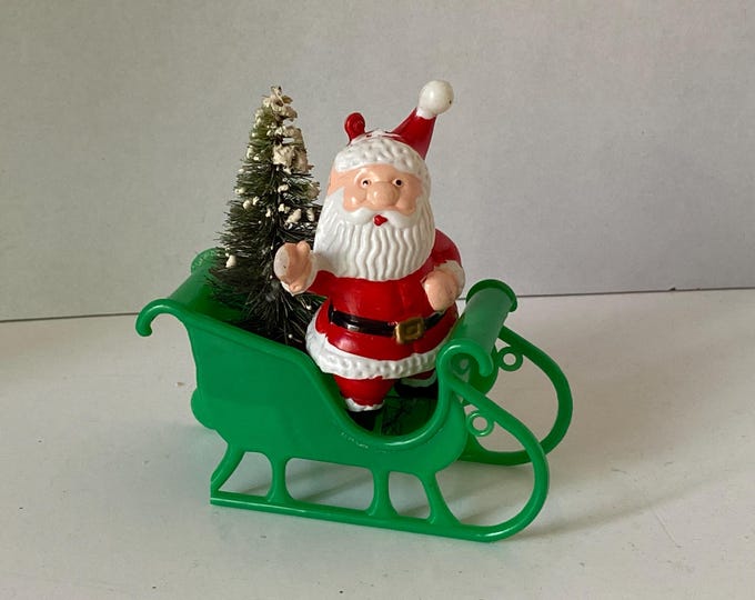 Vintage Celluloid Santa Claus on Green Plastic Sleigh with vintage Christmas Bottle Brush Christmas Tree