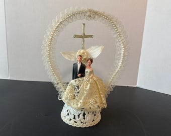 Vintage Plaster  Bride and Groom wedding cake topper with lace dress and round pearl and lace background with cross on plastic stand