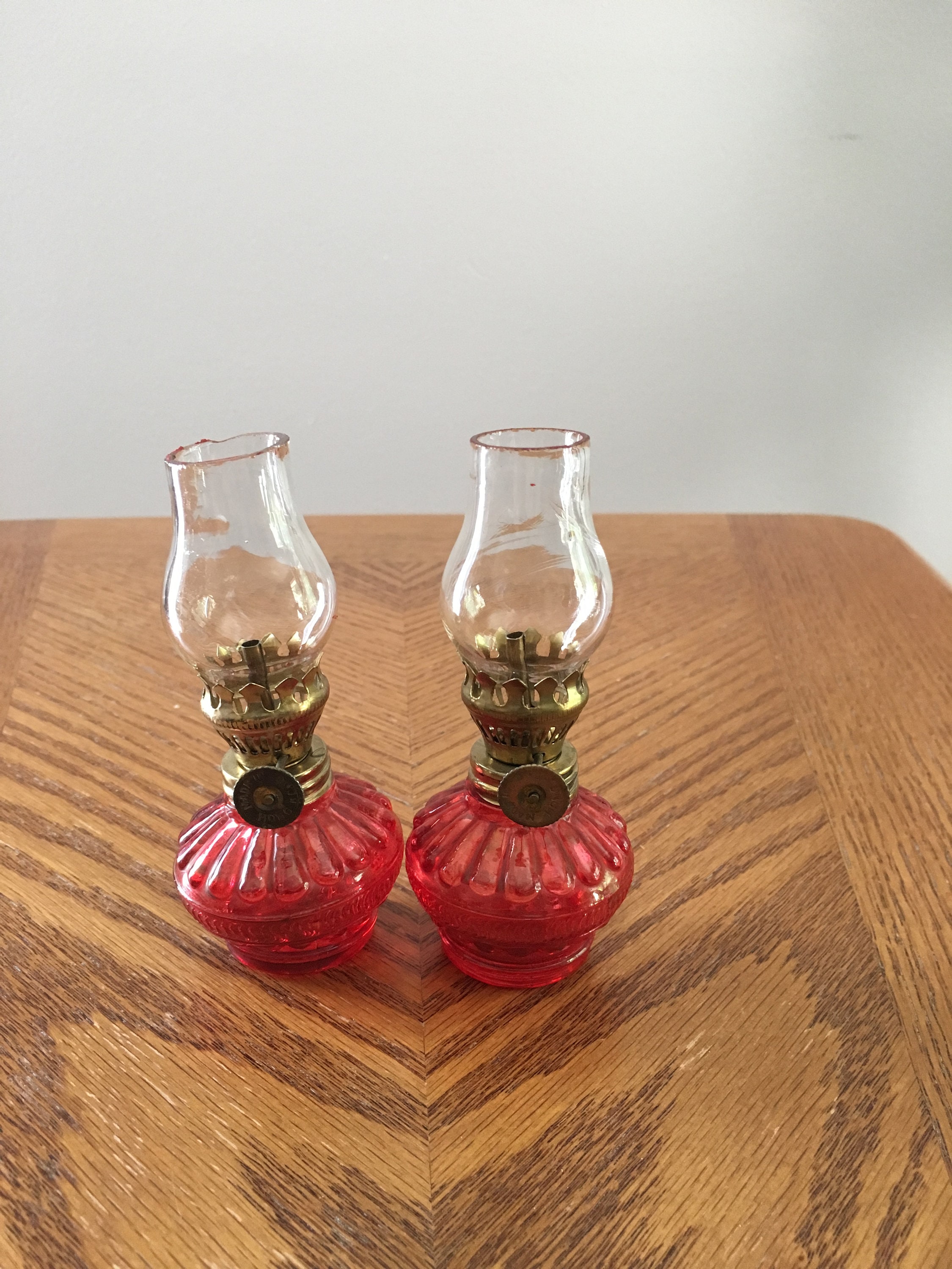 Vintage pair of red minature oil lamps with chimneys