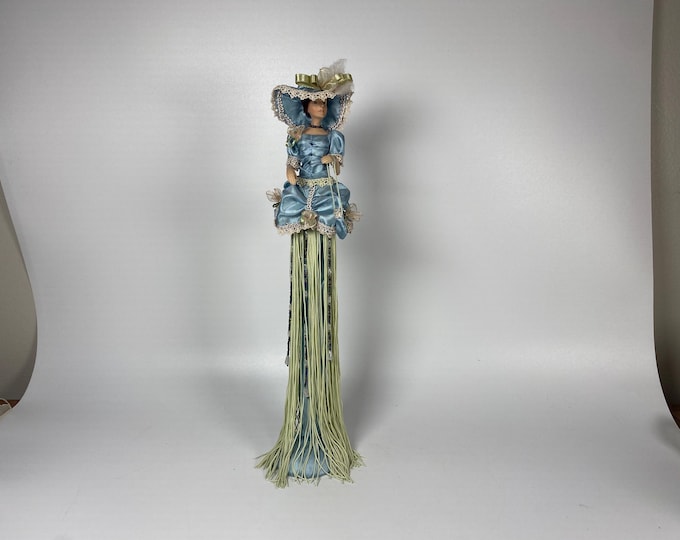 Victorian 15" tall tassel doll in a soft pastel green and sky glue with long, ornate gown,  wide brim feathered hat