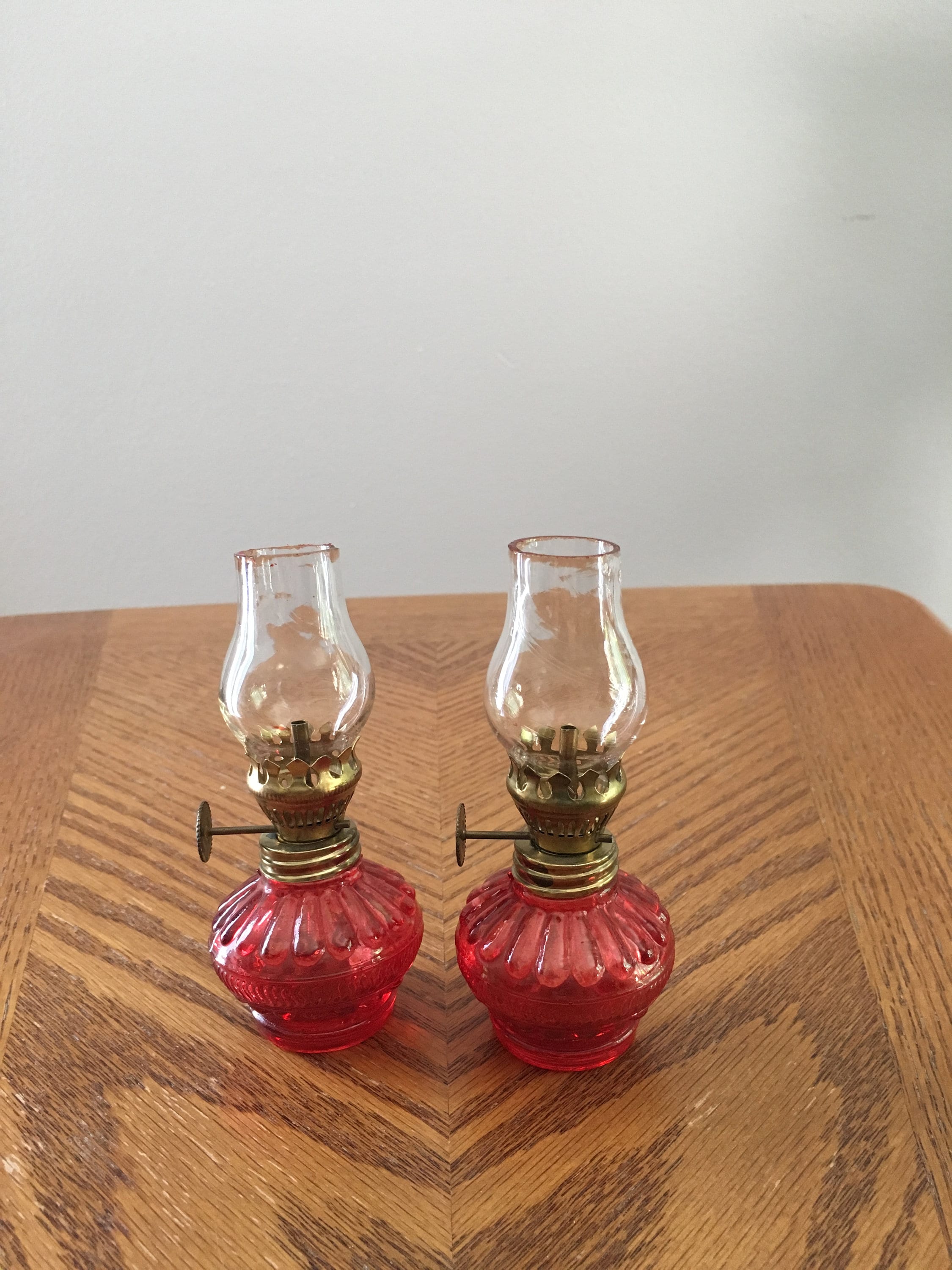 Vintage pair of red minature oil lamps with chimneys