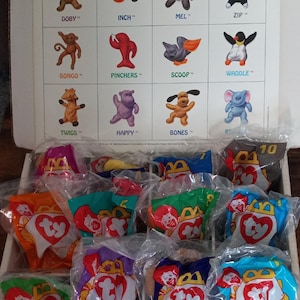May include: A box of 10 Ty Beanie Babies from McDonald's Special Edition Collector's Set. The box contains a variety of characters, including Doby, Inch, Mel, Zip, Bongo, Pinchers, Scoop, Waddle, Twigs, and Happy. Each Beanie Baby is in a clear plastic bag with a Ty tag.
