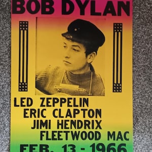 May include: A vintage concert poster for Bob Dylan, with a portrait of Dylan in a black cap. The poster lists other performers: Led Zeppelin, Eric Clapton, Jimi Hendrix, and Fleetwood Mac. The concert date is February 13, 1966, at The Centrum in Worcester, Mass.