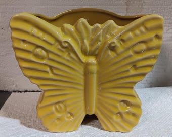 Fjärilsplanter i gult porslinsglas för hemmakontor, samlarobjekt