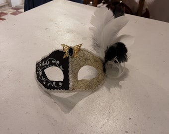 Venetian mask in papier-mâché and baroque decorations