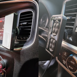 May include: A black car interior with a phone mount and a black control panel with the text "eLEVEL ACCULAIR+." The control panel has multiple buttons with arrows.