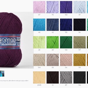 May include: A skein of dark purple yarn labeled "DENIM" with a white label. The yarn is displayed against a white background. A color chart of yarn samples is shown to the right of the yarn skein.