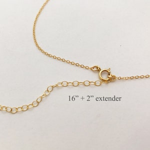 May include: A gold chain necklace with a 16 inch length and a 2 inch extender. The chain is made of small, round links.
