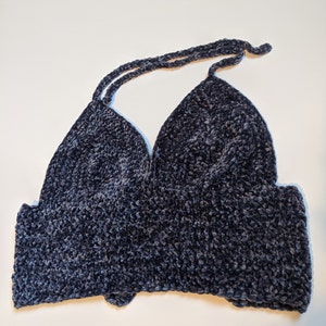 May include: A dark gray crocheted halter top with a v-neckline.