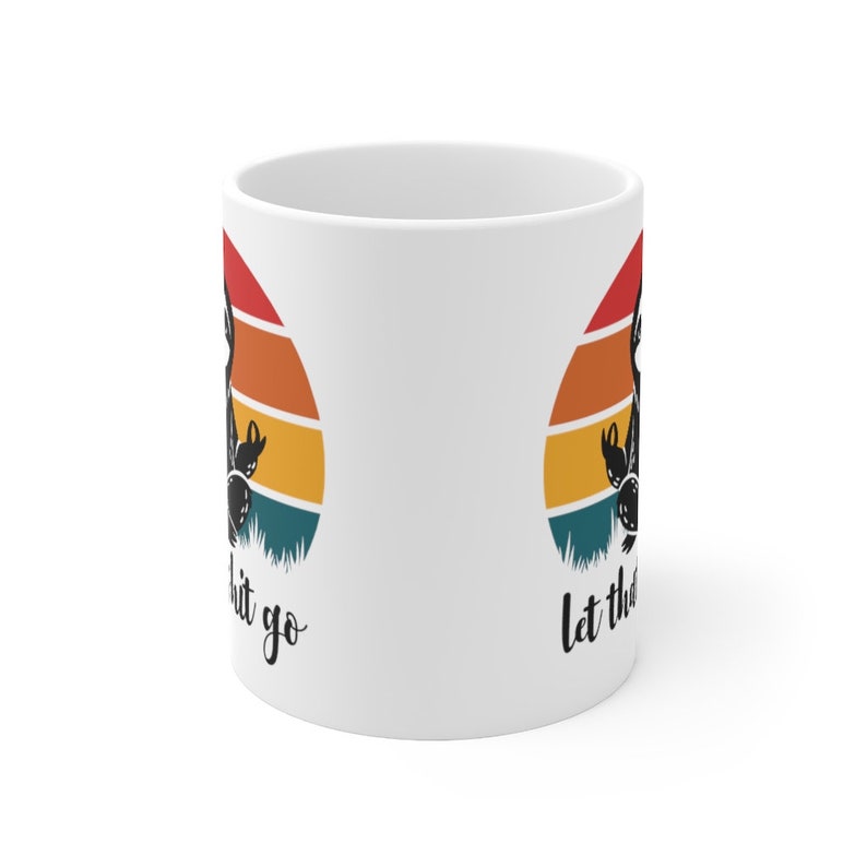 May include: White ceramic mug with a retro sunset design and the text "Let the good shit go" on one side and "Let the good shit go" on the other side.