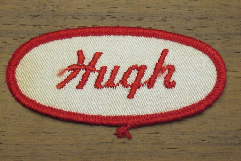 faded work uniform patch with Hugh in red stitching Hugh white