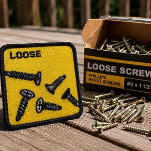 May include: A square yellow embroidered patch with a black border featuring the word LOOSE and four black screw illustrations. Next to it is a cardboard box labeled LOOSE SCREW PHILLIPS WOOD SCREWS #8 x 1 1/2" filled with metal screws.