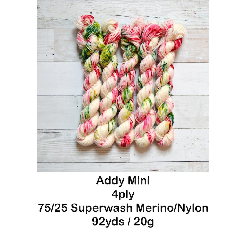May include: Five skeins of yarn in a white base with pink, green, and yellow speckles. The yarn is labeled "Addy Mini 4ply 75/25 Superwash Merino/Nylon 92yds / 20g".