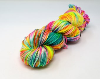 May include: A skein of colorful yarn with a rainbow of colors including pink, yellow, green, blue, and orange.