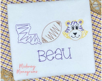May include: White embroidered t-shirt with a purple and yellow tiger face, a football, and the state of Louisiana. The text "Beau" is embroidered in purple below the design. The text "Midway Monograms" is embroidered in pink at the bottom of the shirt.