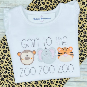 May include: White baby onesie with the text "goin' to the zoo zoo zoo" and embroidered images of a monkey, elephant, and tiger.