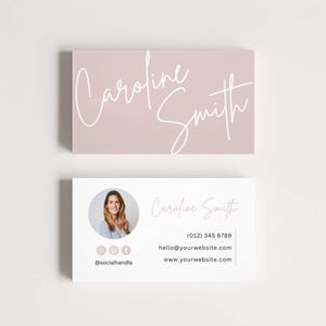 May include: Two business cards. The top card is a rectangular shape with a light mauve background and the name "Caroline Smith" in white cursive script. The bottom card is white with a photo, name, and contact information.
