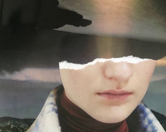 May include: A close-up of a person's face, partially obscured by a torn piece of paper. The person is wearing a red turtleneck sweater and a blue and white patterned jacket. The background is a blurry image of a cloudy sky.