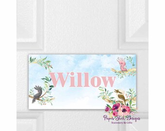 May include: A rectangular sign with the name "Willow" in pink letters against a light blue watercolor background. The sign features illustrations of birds and floral elements, with the text "Paper Shed Designs Stationery & Gifts" at the bottom.