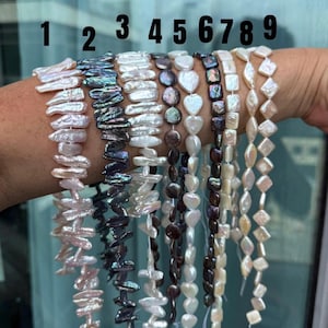 May include: Nine strands of assorted freshwater pearls labeled 1 through 9. The strands feature various shapes including elongated sticks, iridescent dark discs, white hearts, dark squares, and diamond-shaped pearls in white and cream tones.