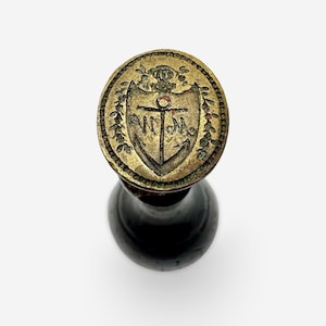 ancient stamp with laurel, anchor and initials