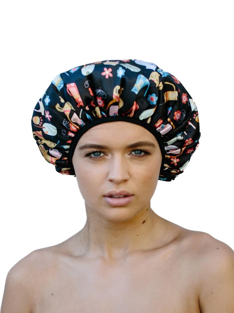 Woman wearing double layer everyday shower cap - black with cats pattern