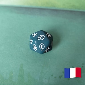 May include: A teal, multi-sided die with white numbers and symbols. The die is set against a green background. The numbers are in a stylized font. The die is a gaming accessory.
