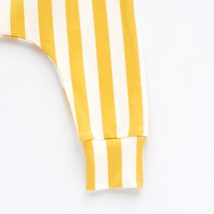 May include: Yellow and white striped pants with a cuffed bottom.