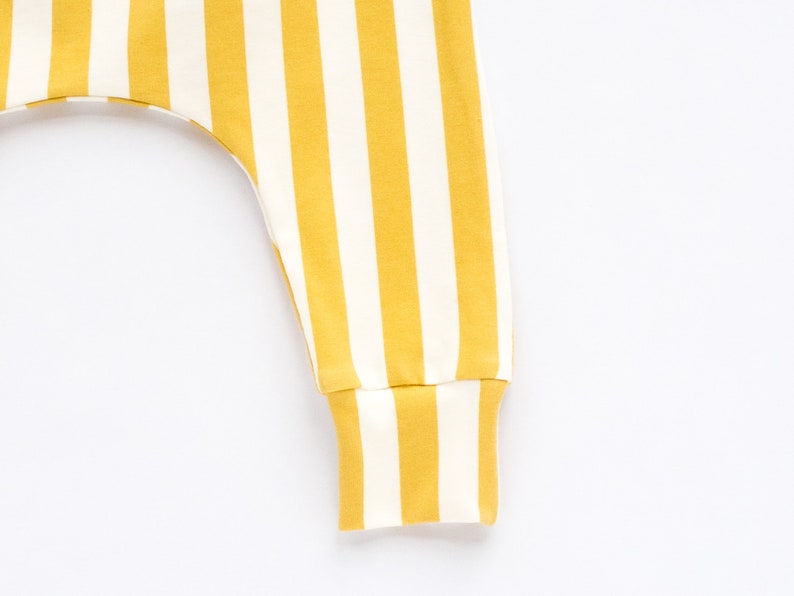 May include: Yellow and white striped pants with a cuffed bottom.