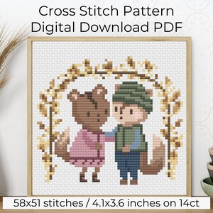 May include: Cross stitch pattern PDF download featuring two brown and tan squirrels with brown eyes, wearing pink and blue clothing, standing under a brown and yellow leafy archway. The pattern is 58x51 stitches and measures 4.1x3.6 inches on 14 count Aida cloth.