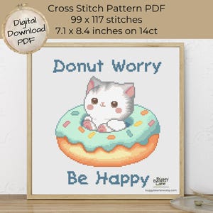 May include: Cross stitch pattern PDF featuring a cute cartoon cat inside a donut with the text "Donut Worry, Be Happy." The design is 7.1 x 8.4 inches and includes 99 x 117 stitches. Digital download.