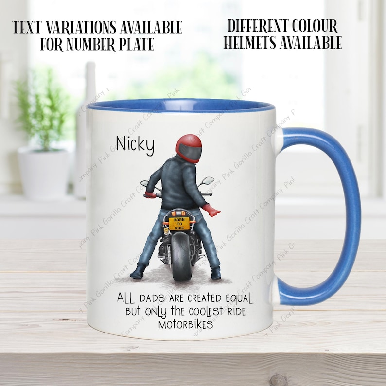 May include: White ceramic mug with a blue rim and handle. The mug features a cartoon illustration of a person riding a motorcycle with the text "Nicky" and "All dads are created equal but only the coolest ride motorbikes".