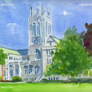 May include: Watercolor painting of a tall, light-colored building with a clock tower, set against a blue sky. Lush green trees and grass frame the building. The artist's signature and website address are visible.