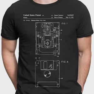 May include: A black t-shirt with a white graphic of a floppy disk patent design. The patent number is 5,629,819 and the date of the patent is May 13, 1997. The text "United States Patent" is also included in the graphic.