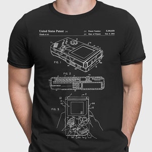 May include: Black t-shirt featuring a white schematic of a handheld gaming device, with the text "United States Patent" and patent details. The shirt also has the text "PATENTPRESS BLACK".
