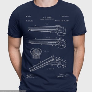 May include: A navy blue t-shirt with a white print of a patent drawing for a breech loading firearm. The patent number is 367,089 and the patent date is July 26, 1887. The drawing shows different views of the firearm.