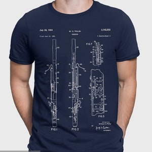 May include: A navy blue t-shirt with a white print of a bassoon patent drawing. The patent drawing includes the text "July 28, 1964", "W. C. POLISI", "BASSOON", "3,142,222", "FIG. 1", "FIG. 2", "FIG. 3", "FIG. 7", "INVENTOR", "William C. Polisi", and "ATTORNEY".