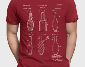 May include: A red t-shirt with a white print of a bowling pin patent design. The patent number is 3,353,258 and the date is November 21, 1967. The patent drawing shows different views of the bowling pin.