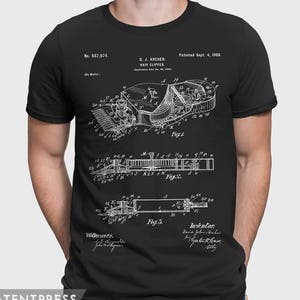 May include: Black t-shirt with a white print of a patent for a hair clipper. The patent number is 657,074 and the patent date is September 4, 1900. The inventor is D.J. Archer.